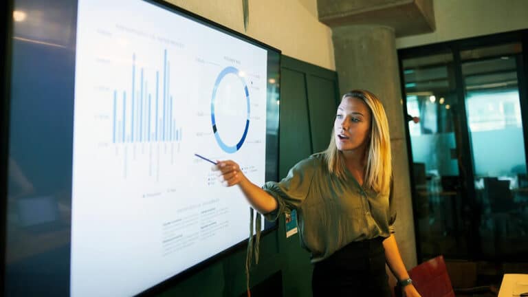 Analyst pointing at display screen