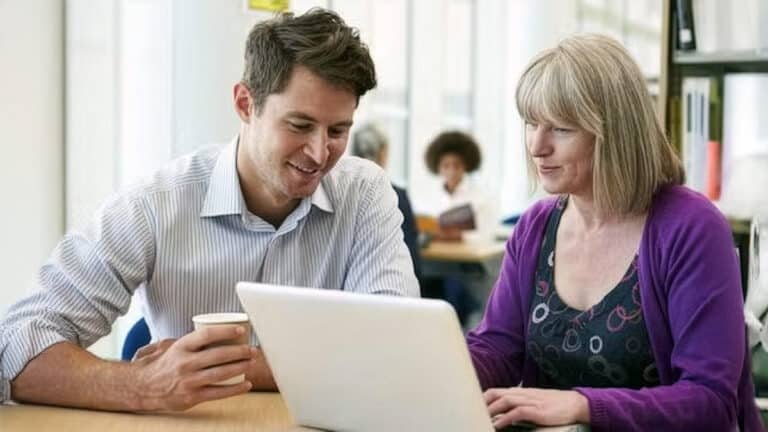 Colleagues working with laptop