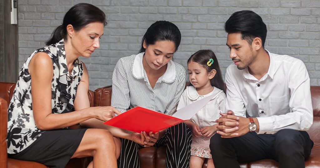 Education professional with parents and young daughter