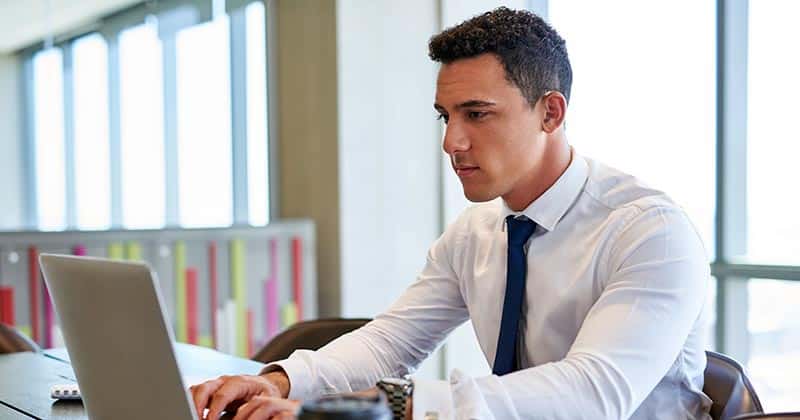 Man at office working on laptop