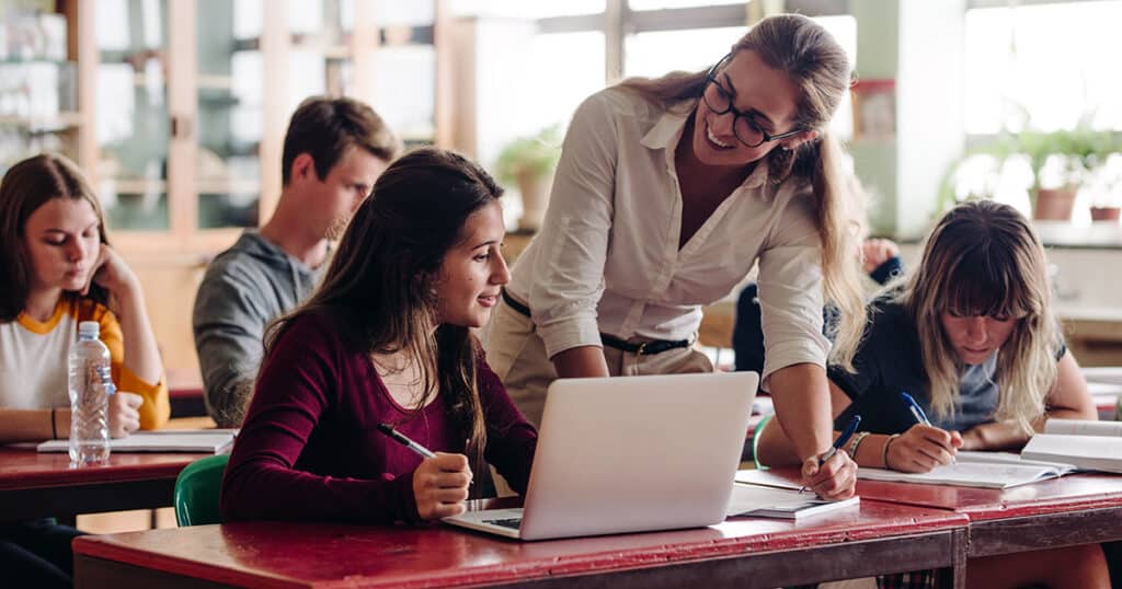 Teacher helping a student with her work